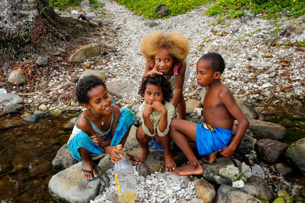 Children play by the river along the Lavena Coastal Walk on Taveuni Island. (Don Mammoser/ Shutterstock)