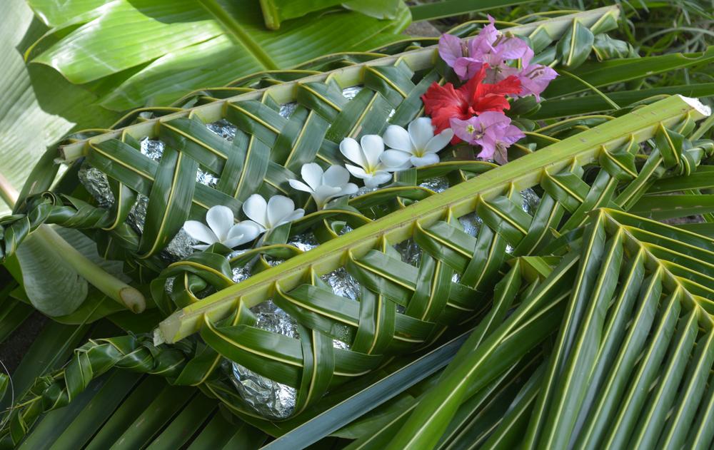 A Fijian lovo is a traditional underground and banana-leaf wrapped cooking method that's prepared for special events such as holidays. (ChameleonsEye/ Shutterstock)