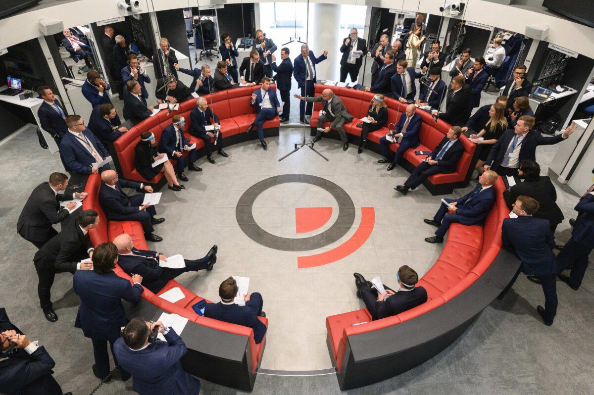 Traders, brokers, and clerks shout and gesture on the first day of in-person trading at the London Metal Exchange in London on Sept. 6, 2021. (Leon Neal/Getty Images)