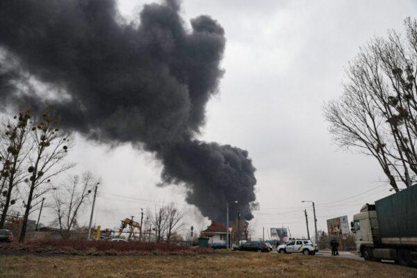  Black smoke billows after authorities said a missile attack hit an industrial area of Lviv, Ukraine, on March 26, 2022. (Charlotte Cuthbertson/The Epoch Times)