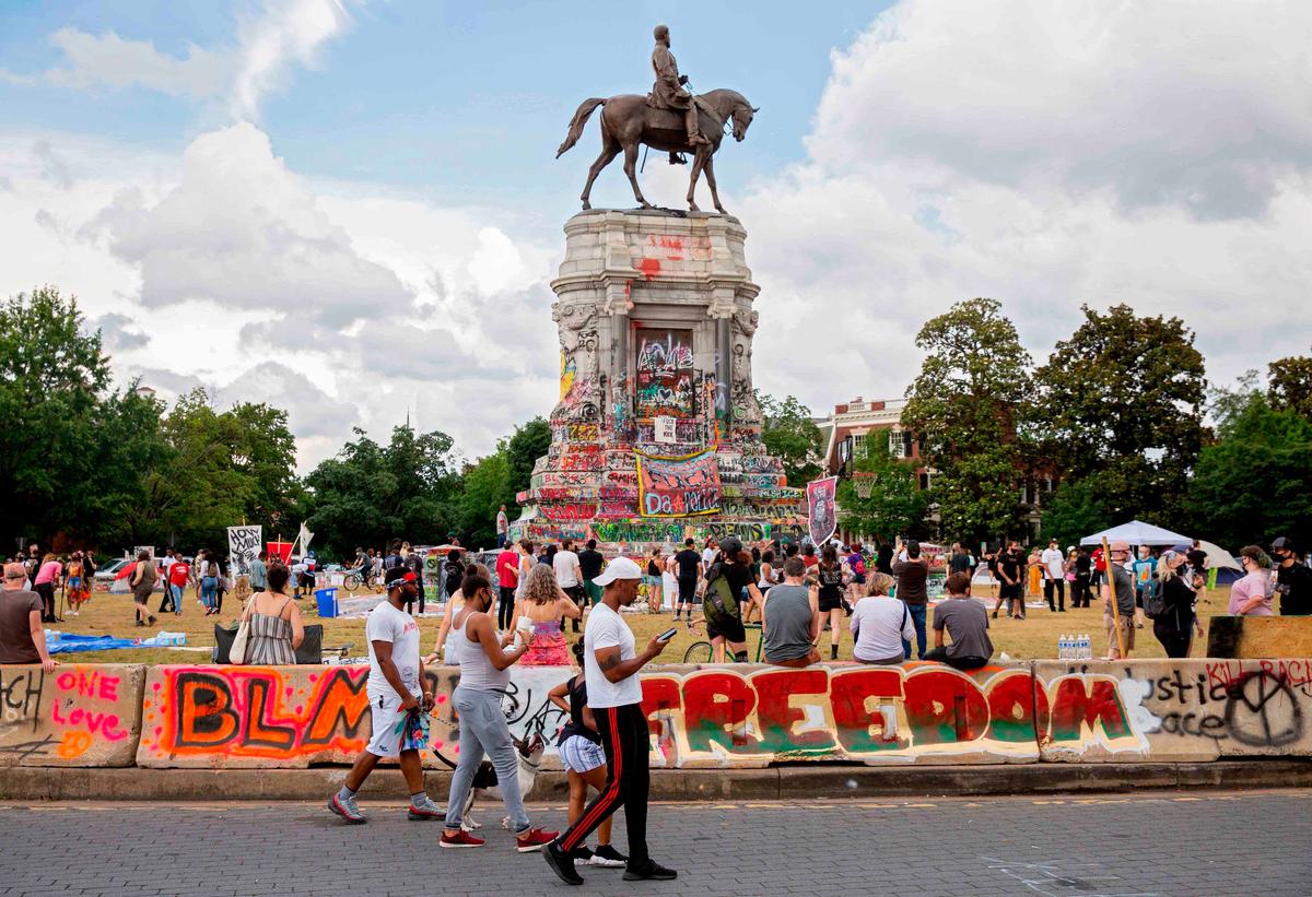 People gather around the Robert E. Lee statue on Monument Avenue in Richmond, Virginia, on June 20, 2020. (Ryan M. Kelly/AFP via Getty Images)