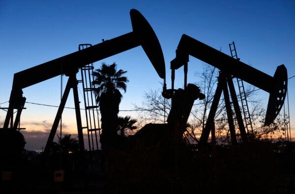 An oil pumpjack (L) operates as another (R) stands idle in the Inglewood Oil Field in Los Angeles on Jan. 28, 2022. (Mario Tama/Getty Images)