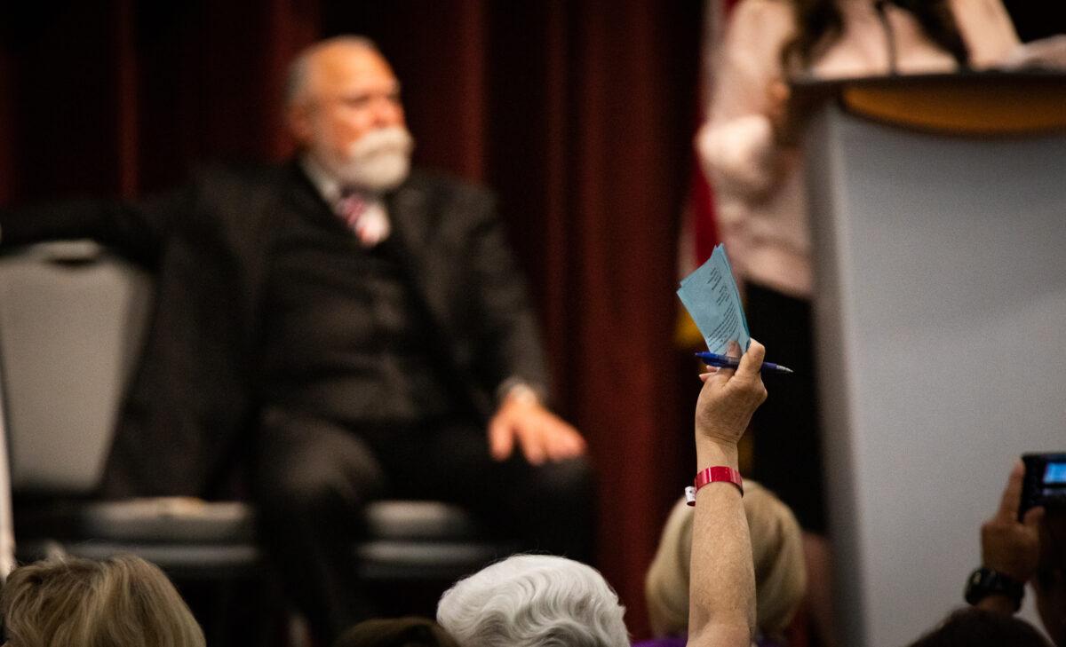 A woman holds a ballot for pick up as California Republican candidates speak at the Yorba Linda Community Center in Yorba Linda, Calif., on March 24, 2022. (John Fredricks/The Epoch Times)