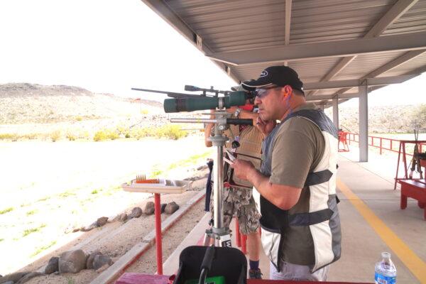 Gerald Hernandez of Amarillo, Texas, spots for his partner at a shooting competition at the Ben Avery Shooting Facility in Phoenix, on March 26. (Allan Stein/The Epoch Times)