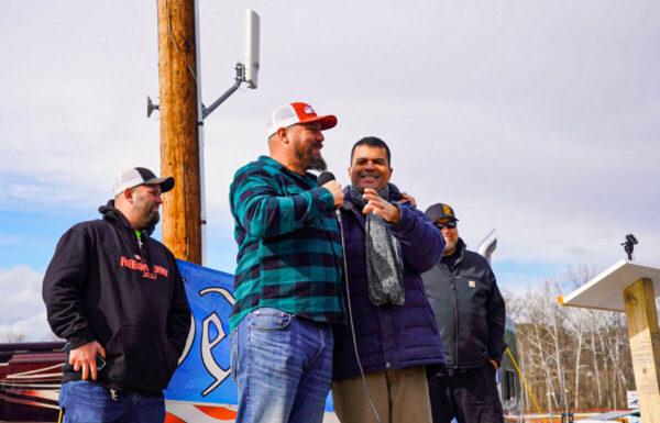 (L to R) The People’s Convoy co-organizer Mike Landis, co-organizer Brian Brase, the Unity Project’s Chief Scientific Officer Dr. Paul Alexander, and emcee Marcus Summers at a rally at Hagerstown Speedway in Hagerstown, Md., on Mar. 26, 2022. (Terri Wu/The Epoch Times)