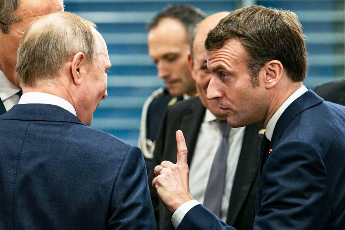 French President Emmanuel Macron (R) speaks with Russian President Vladimir Putin (L) before a meeting at the Chancellery on January 19, 2020, in Berlin, Germany. (Emmanuele Contini/Getty Images)
