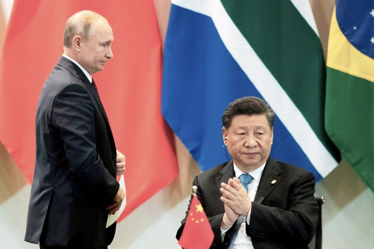 Chinese leader Xi Jinping and Russian President Vladimir Putin attend a meeting with members of the Business Council and management of the New Development Bank during the BRICS Summit in Brasília on Nov. 14, 2019. (Pavel Golovkin/Pool/AFP via Getty Images)