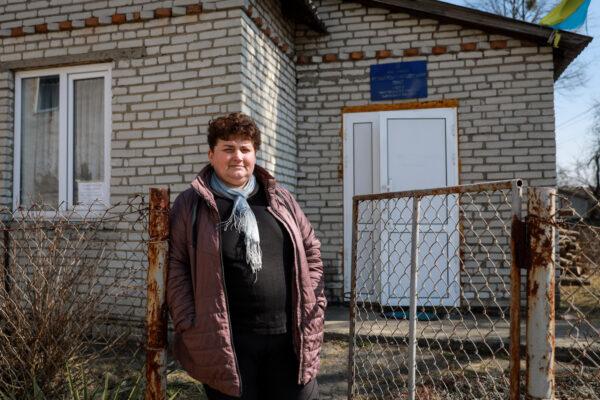 Oksana stands outside a local medical office in Koty, Ukraine, on March 25, 2022. (Charlotte Cuthbertson/The Epoch Times)