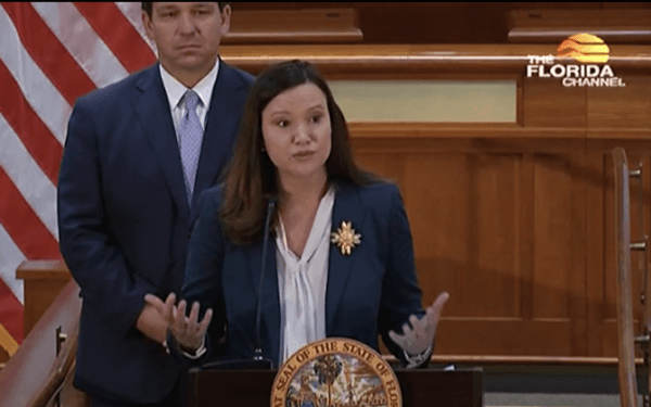 Florida Attorney General Ashley Moody speaks at a press conference at the Florida Capitol in Tallahassee March 29, as Gov. Ron DeSantis looks on. (The Florida Channel)