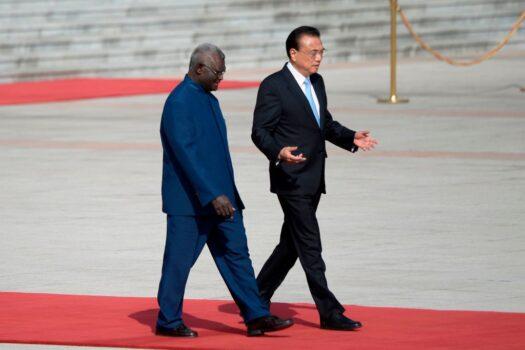 Solomon Islands Prime Minister Manasseh Sogavare (L) talks with Chinese Premier Li Keqiang as they prepare to inspect honour guards during a welcome ceremony at the Great Hall of the People in Beijing, China, on Oct 9, 2019. (Wang Zhao/AFP via Getty Images)