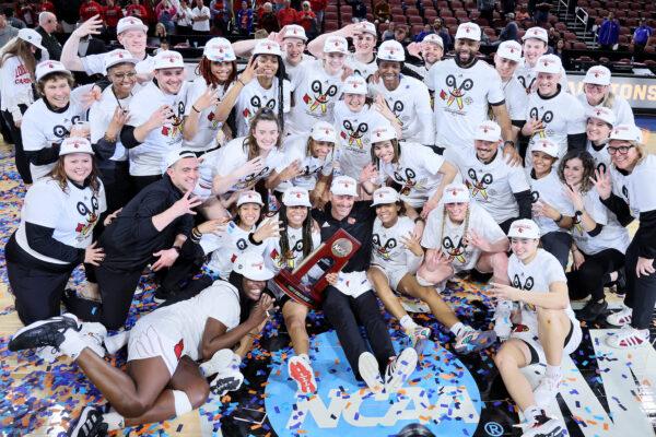 The Louisville Cardinals celebrate with the Regional Championship trophy after the 62-50 win over the Michigan Wolverines in the Elite Eight round game of the 2022 NCAA Women's Basketball Tournament at Intrust Bank Arena, in Wichita, Kansas, on March 28, 2022. (Andy Lyons/Getty Images)