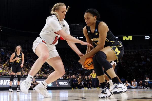Hailey Van Lith #10 of the Louisville Cardinals competes for the ball against Naz Hillmon #00 of the Michigan Wolverines during the first half in the Elite Eight round game of the 2022 NCAA Women's Basketball Tournament at Intrust Bank Arena, in Wichita, Kansas, on March 28, 2022. (Andy Lyons/Getty Images)