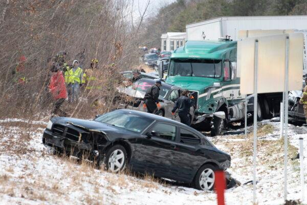 Emergency personnel work at the scene of a multi-vehicle crash on Interstate 81 North near the Minersville exit in Foster Township, Pa., on March 28, 2022. (David McKeown/Republican-Herald via AP)