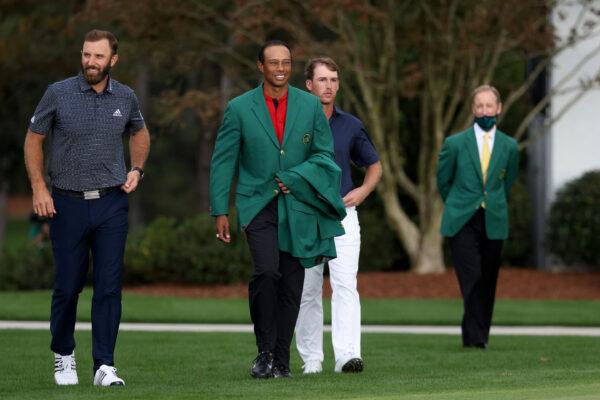 Dustin Johnson of the United States walks to the putting green to be awarded the Green Jacket by Masters champion Tiger Woods of the United States during the Green Jacket Ceremony after winning the Masters during the final round of the Masters at Augusta National Golf Club in Augusta, Georgia, on Nov. 15, 2020. (Rob Carr/Getty Images)