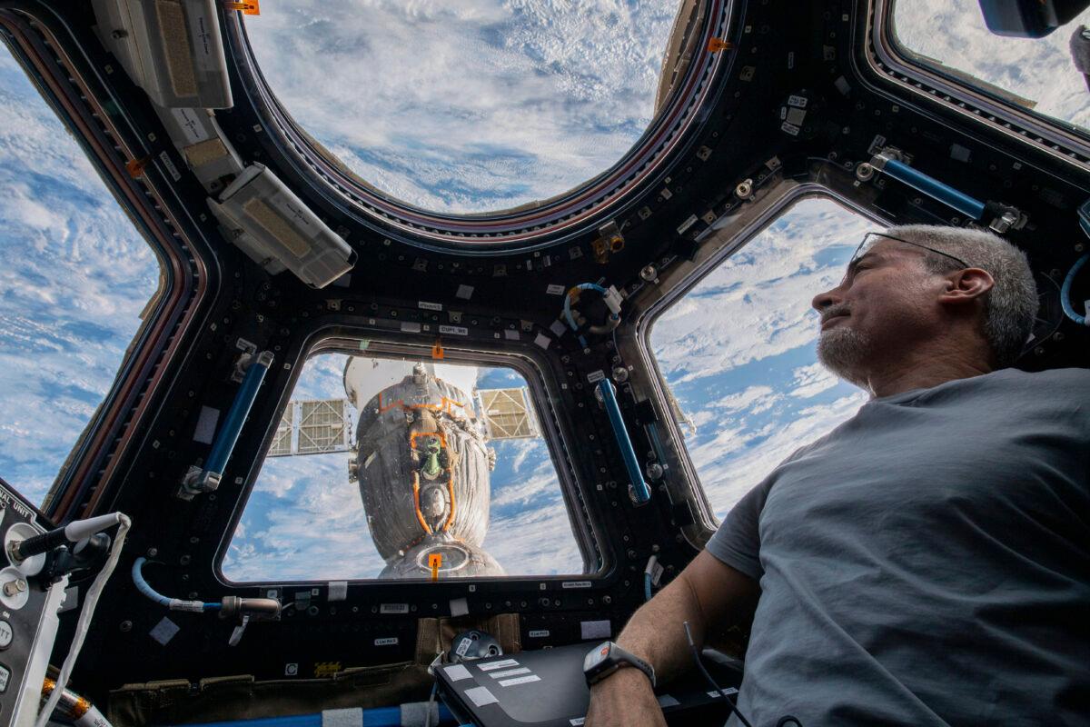 U.S. astronaut and Expedition 66 Flight Engineer Mark Vande Hei peers at the Earth below from inside the seven-windowed cupola, the International Space Station's window to the world, on Feb. 4, 2022. (Kayla Barron/NASA via AP)