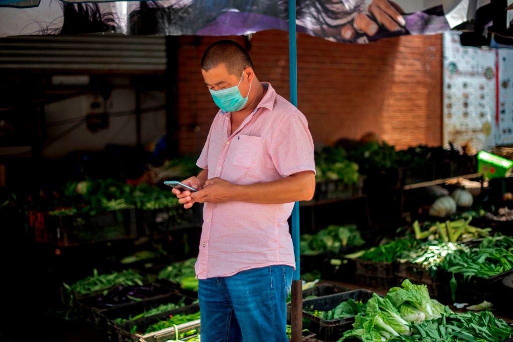 A man wears a protective face mask as he works at a vegetable market in Cyrildene, South Africa, also known as Johannesburg's China Town on Feb. 7, 2020. (Luca Sola/AFP via Getty Images)