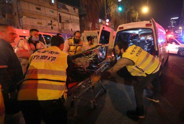 Members of Israel's emergency services evacuate a body from the scene of a shooting attack in Bnei Brak, Israel, on March 29, 2022. (Gil Cohen-Magen/AFP via Getty Images)