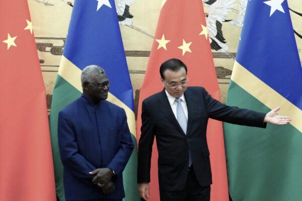 Chinese Premier Li Keqiang shows the way to Solomon Islands Prime Minister Manasseh Sogavare, in Beijing, China, on Oct. 9, 2019. (Thomas Peter/Pool/AFP via Getty Images)