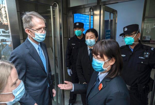 Australian Ambassador to China Graham Fletcher (left) is turned away by court officials and police as he tries to enter the trial of Chinese Australian journalist Cheng Lei at the Beijing Number 2 Intermediate People’s Court in Beijing, China, on March 31, 2022. (Kevin Frayer/Getty Images)