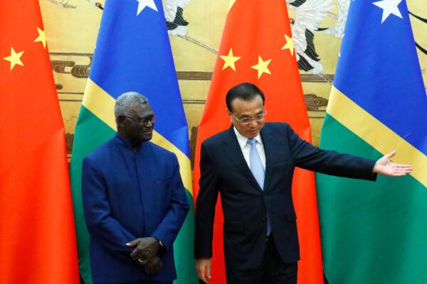 Chinese Premier Li Keqiang shows the way to Solomon Islands Prime Minister Manasseh Sogavare, in Beijing, China, on Oct. 9, 2019. (Thomas Peter/Pool/AFP via Getty Images)