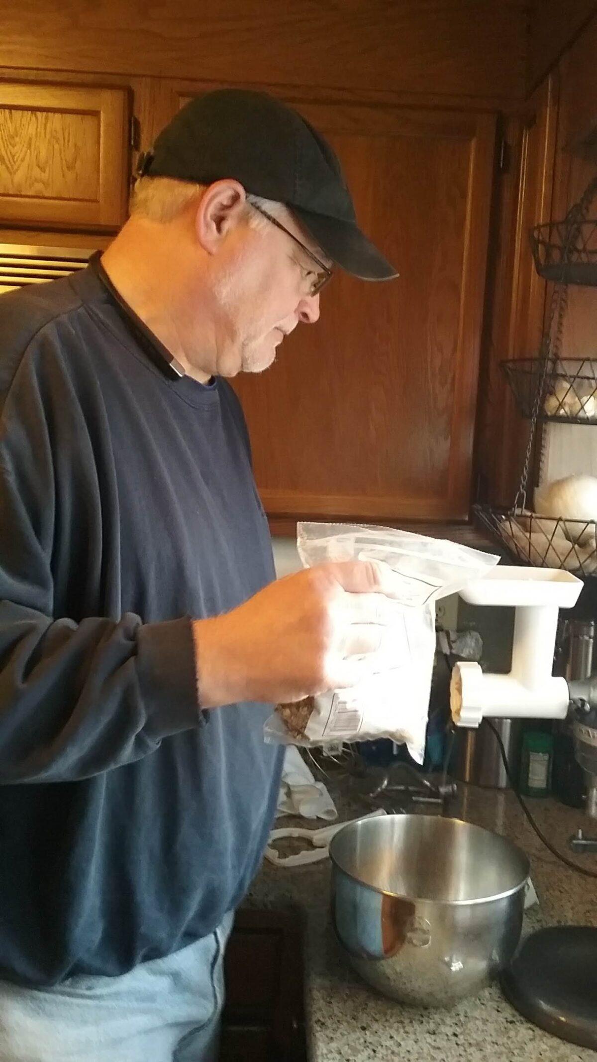 "Dough Whisperer" Mitch Brady grinds walnuts for a batch of his perfected nut rolls. (Courtesy of Mary Lou Young)