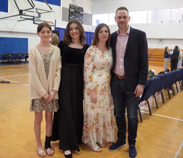 Travis Lassiter with wife Rachel, daughters Claire (L), and Kendall at Evergreen Christian School in Leesburg, Va., on Apr. 23, 2022. (Terri Wu/The Epoch Times)