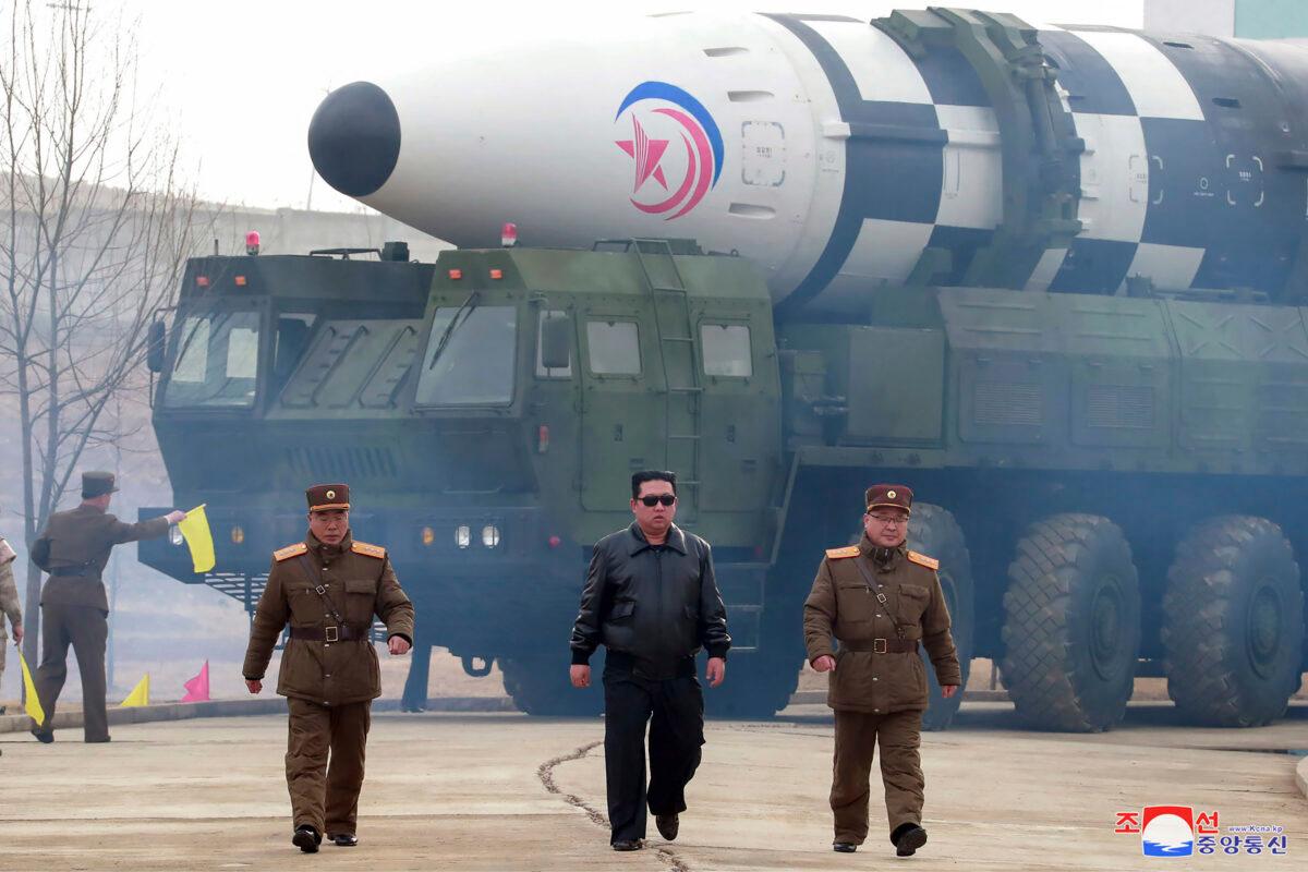 North Korean leader Kim Jong Un (C) walks around what it says is a Hwasong-17 intercontinental ballistic missile (ICBM) on the launcher, at an undisclosed location in North Korea, on March 24, 2022. (Korean Central News Agency/Korea News Service via AP)