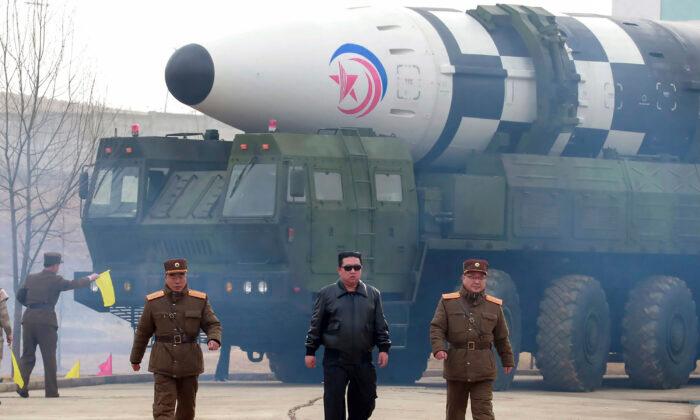 North Korean leader Kim Jong Un (C) walks around what North Korea claims is Hwasong-17 intercontinental ballistic missile on the launcher, at an undisclosed location in North Korea, on March 24, 2022. (Korean Central News Agency/Korea News Service via AP)