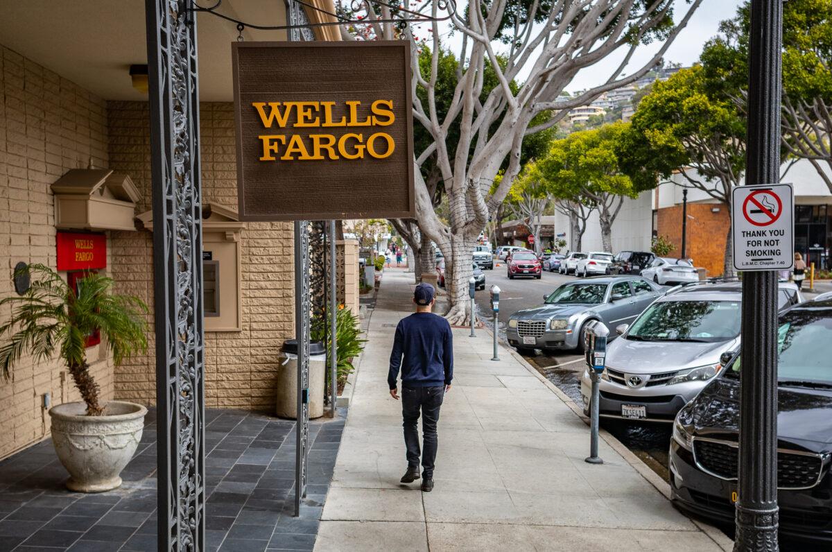 A man walks past a Wells Fargo bank in Laguna Beach, Calif., on April 1, 2022. (John Fredricks/The Epoch Times)