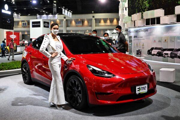 A model promotes the Tesla Model Y electric car at the Bangkok International Motor Show in Bangkok, Thailand on March 24, 2022. (LILLIAN SUWANRUMPHA/AFP via Getty Images)