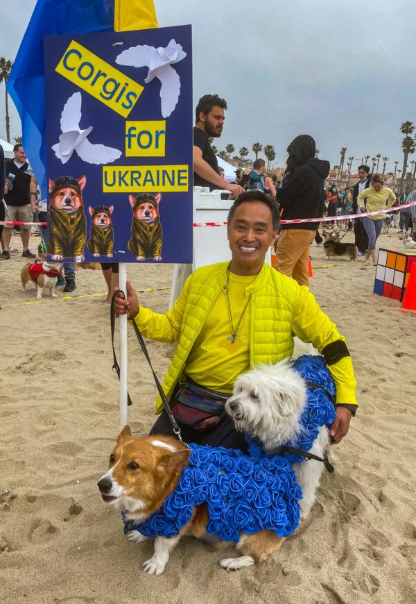 Rick Garcia dressed his four dogs in yellow and blue roses to match the Ukrainian flag, parading them through the “Best Anything Goes Costume Contest” in Huntington Beach, Calif., on April 2, 2022. (Carol Cassis/The Epoch Times)