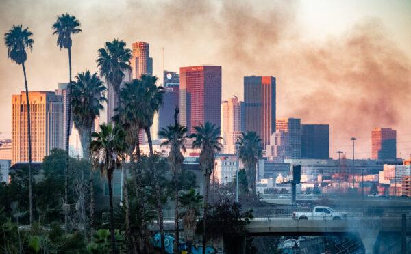 Fires within a homeless encampment create smoke in Los Angeles on Jan. 2, 2022. (John Fredricks/The Epoch Times)