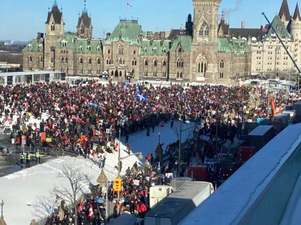 People gather on Parliament Hill on the first day of the Freedom Convoy protest against COVID-19 mandates and restrictions in Ottawa on Jan. 29, 2022. (Limin Zhou/The Epoch Times)