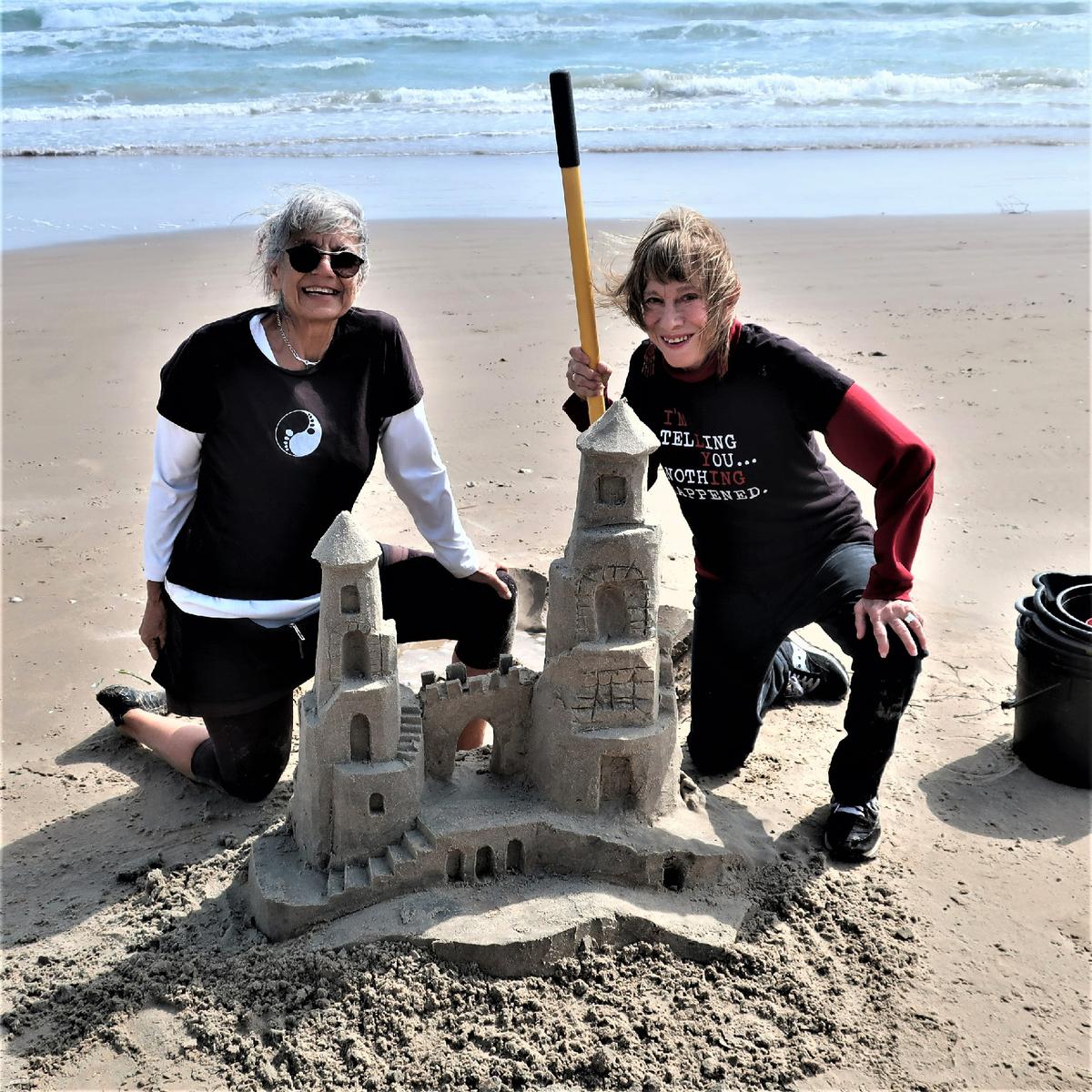Lucinda Wierenga (L) gives the author a lesson on how to build a sandcastle on South Padre Island, Texas. (Victor Block)