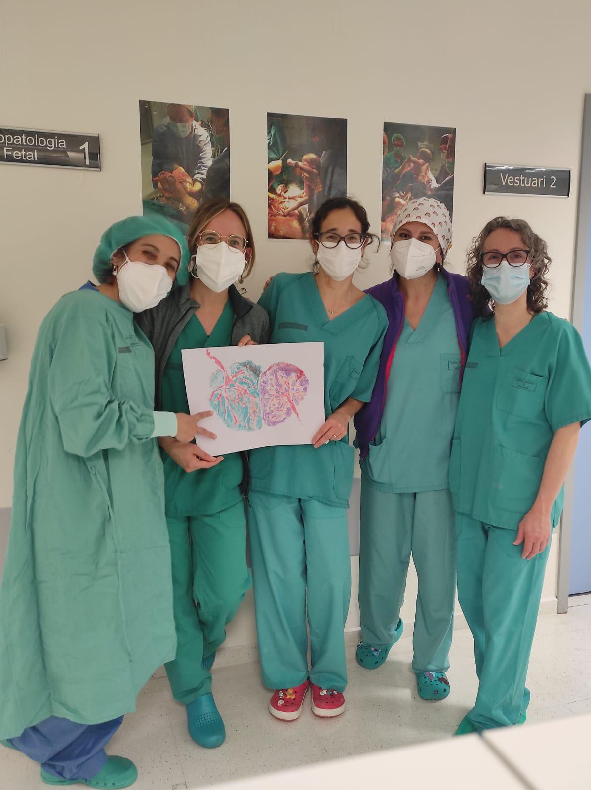 Ana Teijero with other doctors and their painting, at GVA Salut Vinaròs, after the twins were born. (Courtesy of Ana Teijelo Deiros)
