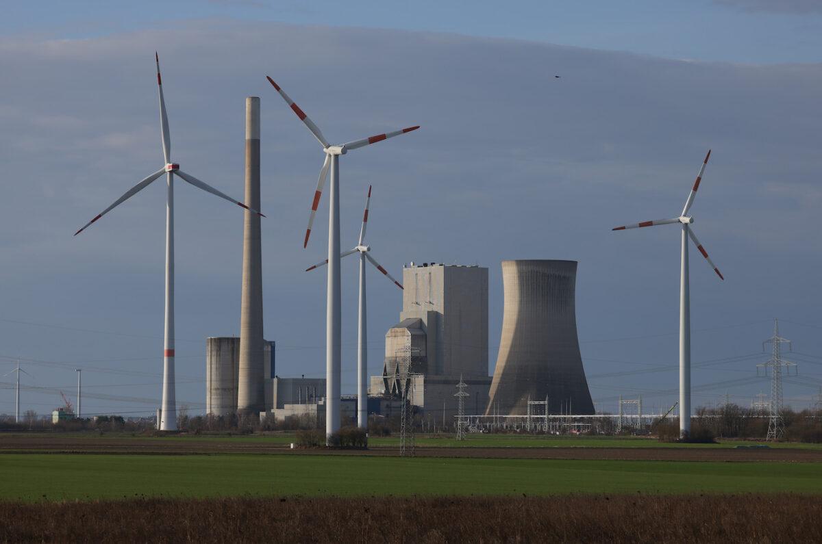 Wind turbines spin near the coal-fired Mehrum Power Station in Mehrum, Germany, on Feb. 14, 2022. (Sean Gallup/Getty Images)