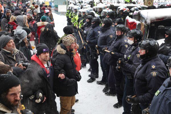 Police confront demonstrators participating in the Freedom Convoy protest opposing vaccine mandates in Ottawa on Feb. 19, 2022. (Scott Olson/Getty Images)