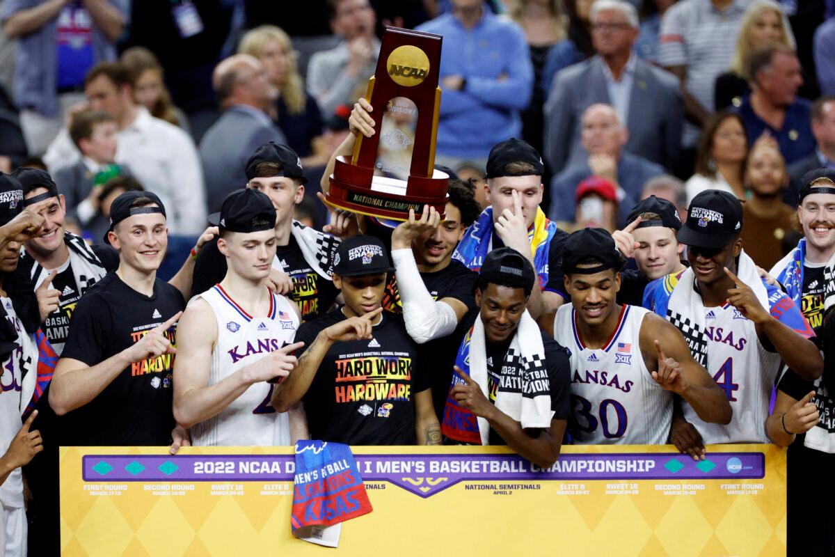 Kansas Jayhawks players and coaches pose with the trophy after defeating the North Carolina Tar Heels 72-69 during the 2022 NCAA Men's Basketball Tournament National Championship at Caesars Superdome, in New Orleans, on April 4, 2022. (Chris Graythen/Getty Images)