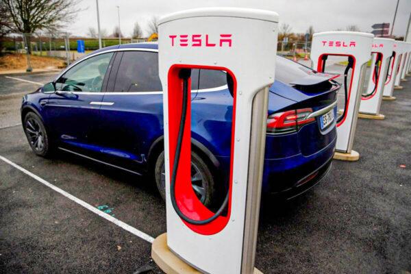A driver recharges the battery of his Tesla car at a Tesla Super Charging station in a petrol station on the highway in Sailly-Flibeaucourt, France, on Jan. 12, 2019. (Pascal Rossignol/Reuters)
