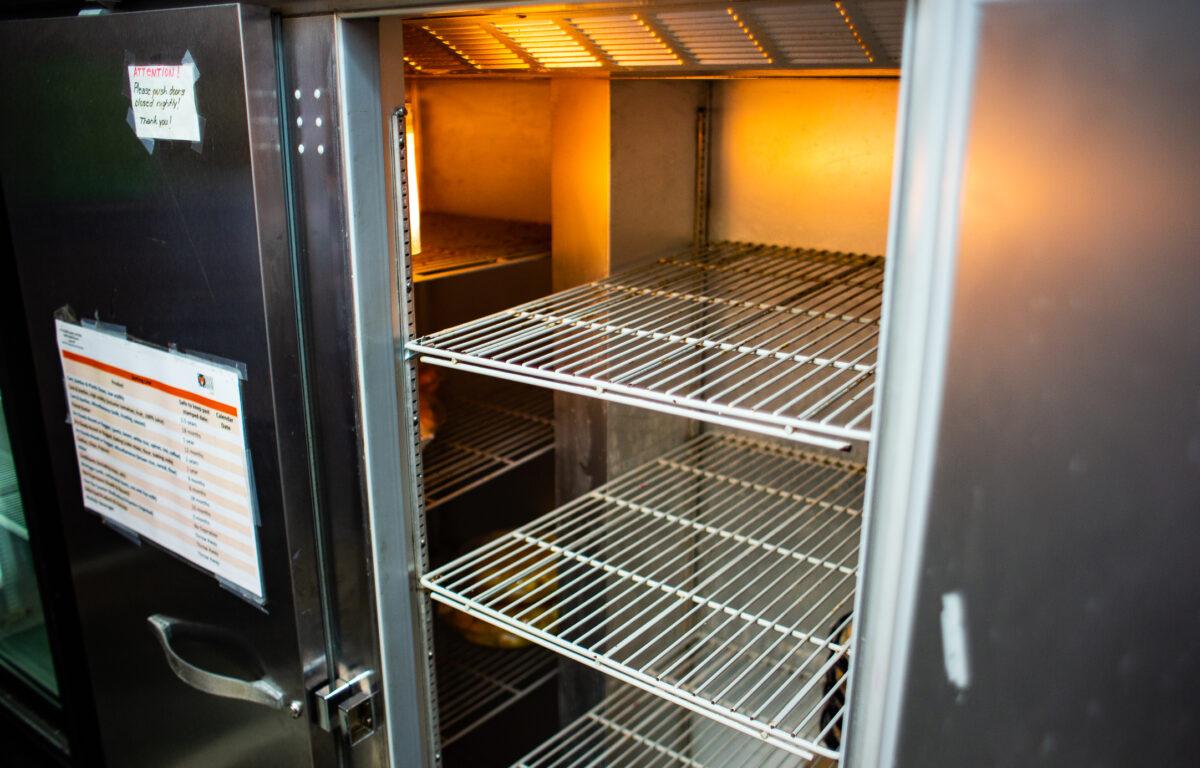An empty fridge marks the end of a days work for the food ministry at Friendship Baptist Church in Yorba Linda, Calif., on April 5, 2022. (John Fredricks/The Epoch Times)