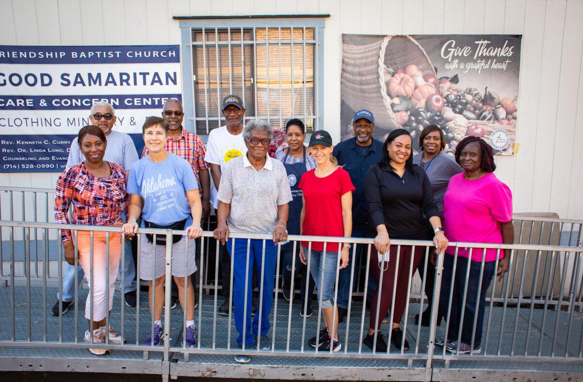 Volunteers of the food pantry ministry stand for a photo in front of Friendship Baptist Church in Yorba Linda, Calif., on April 5, 2022. (John Fredricks/The Epoch Times)