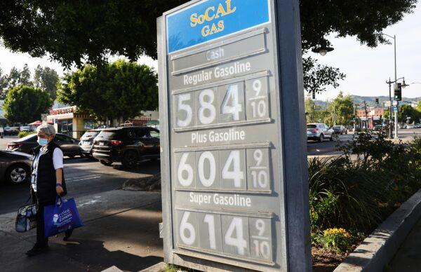 A pedestrian walks past a gas station advertising gas prices in Los Angeles, on March 25, 2022. (Mario Tama/Getty Images)