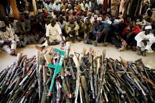 Members of the Yansakai vigilante group sit inside an auditorium at the Zamfara state Government House as their members surrendered more than 500 guns to  Gov. Bello Matawalle, as part of efforts to accept the peace process in 2019. (Kola Sulaimon/AFP via Getty Images)