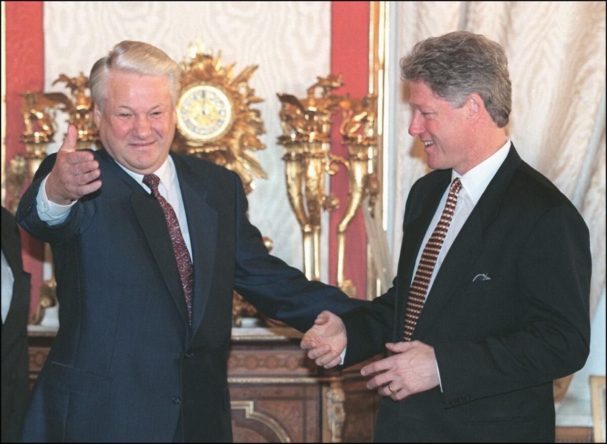U.S. President Bill Clinton (R) and Russian President Boris Yeltsin greet each other in the Green room at the Kremlin in Moscow, Russia, on Jan. 13, 1994. (Luke Frazza/AFP via Getty Images)