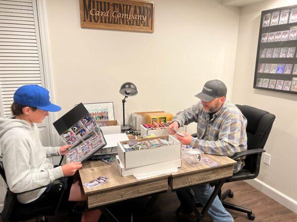 Ohio's Sam Muhlenkamp (R) and his son, Colten, sort through some of their favorite baseball cards in their card room on April 5, 2022. Muhlenkamp, 46, used to collect cards as a boy and now he and his son share the fun and passion for the hobby. (Courtesy of Stephanie Muhlenkamp)