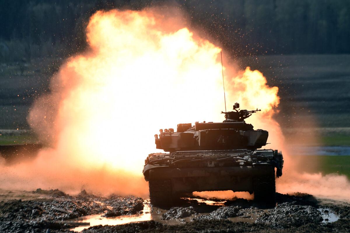 A Belarusian T-72 tank shoots at a target during a tank biathlon competition outside Minsk, Belarus, on April 21, 2018. (Sergei Gapon/AFP/Getty Images)