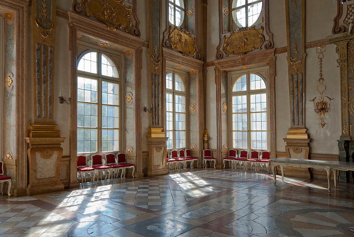 <span data-sheets-value="{"1":2,"2":"Marble Hall is a Baroque dream of colored marble and gold-painted stuccowork. Over two stories in height, the magnificent room marries the gravity of the Neoclassical with the light whimsy of Rococo ornamentation. The tall, arched windows cast natural light across the room’s many colors and details which include its wonderfully tiled floors, marble pilasters, and gold-painted reliefs. (WOKRIE/CC BY-SA 3.0 Austria)"}" data-sheets-userformat="{"2":13059,"3":{"1":0},"4":{"1":2,"2":2228223},"11":4,"12":0,"15":"Arial","16":10}">Marble Hall is a Baroque dream of colored marble and gold-painted stuccowork. Over two stories in height, the magnificent room marries the gravity of the Neoclassical with the light whimsy of Rococo ornamentation. The tall, arched windows cast natural light across the room’s many colors and details which include its wonderfully tiled floors, marble pilasters, and gold-painted reliefs. (WOKRIE/CC BY-SA 3.0 Austria)</span>