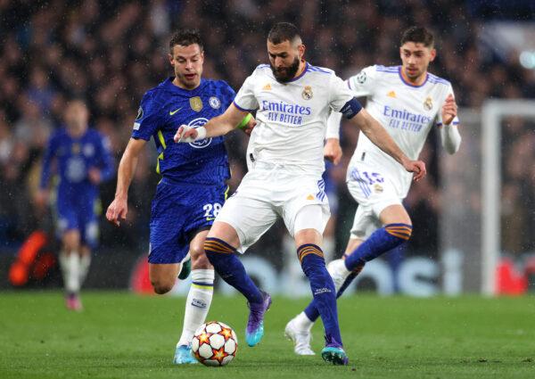 Karim Benzema of Real Madrid is challenged by Cesar Azpilicueta of Chelsea during the UEFA Champions League Quarter Final Leg One match between Chelsea FC and Real Madrid at Stamford Bridge, in London, on April 6, 2022. (Catherine Ivill/Getty Images)