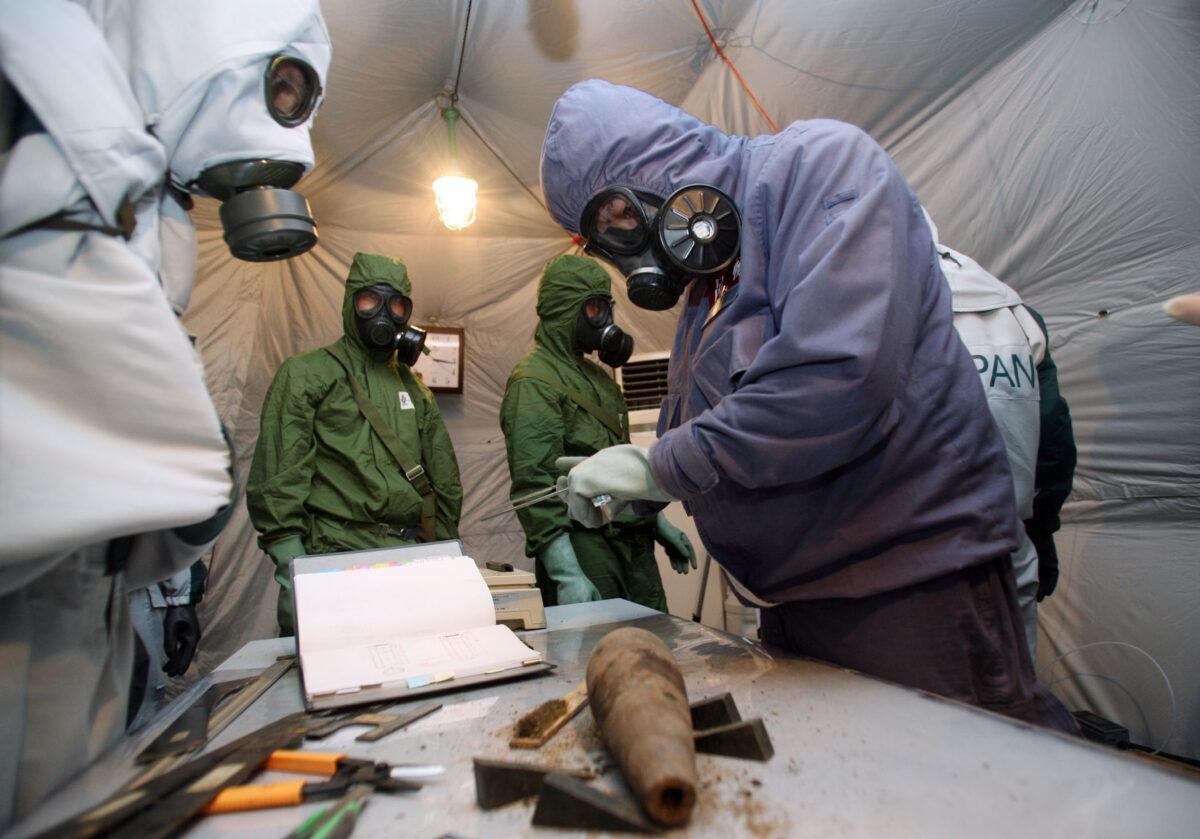Chinese and Japanese experts investigate and categorize munitions excavated from a site known to contain Japanese chemical weapons left behind from World War II in Mudanjiang, in China's northern Heilongjiang Province, on July 5, 2006. (Natalie Behring/Bloomberg via Getty Images)