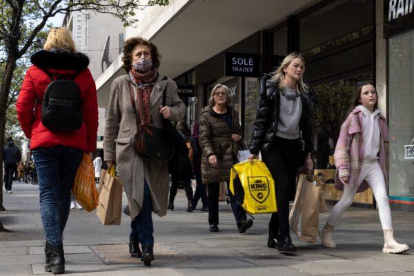Members of the public walk along Oxford Street in London, on April 1, 2022. (Dan Kitwood/Getty Images)